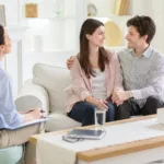 Happy couple at successful therapy session with family psychologist