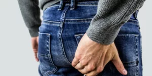 Man in jeans holding backside