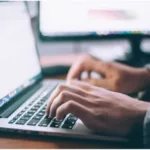 online typing laptop hands