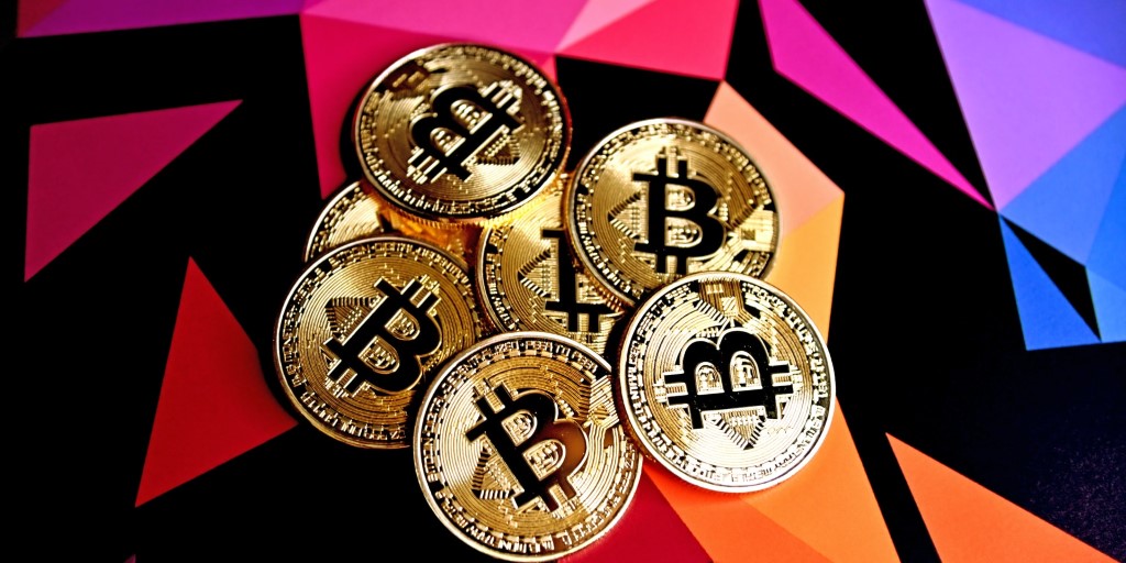 bitcoins on a multi colored background