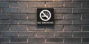 minimal shot of no smoking sign on brick wall